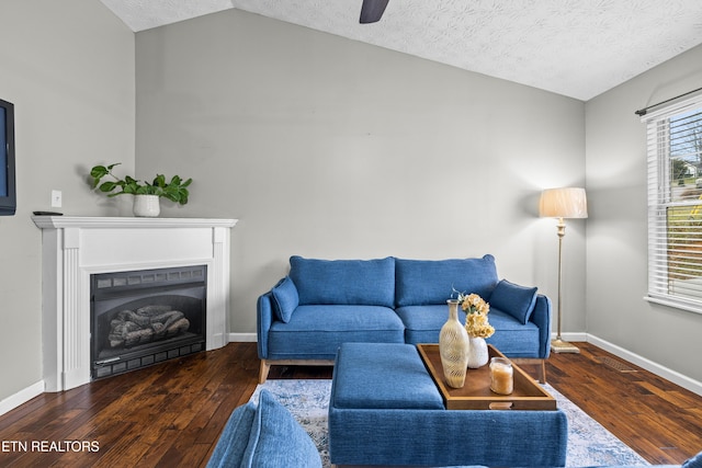 living room featuring a textured ceiling, ceiling fan, vaulted ceiling, and dark hardwood / wood-style flooring