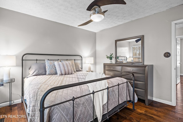 bedroom featuring a textured ceiling, ceiling fan, and dark hardwood / wood-style flooring