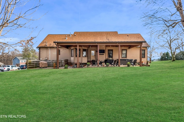 rear view of house featuring a lawn and a patio area