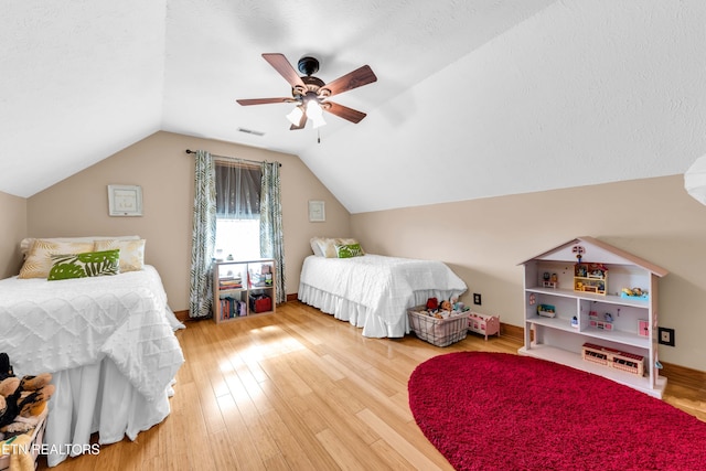 bedroom with lofted ceiling, hardwood / wood-style floors, and ceiling fan