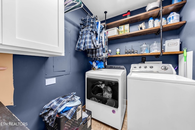 laundry area featuring washer and clothes dryer and cabinets