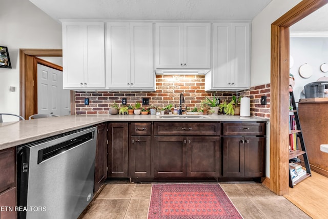 kitchen with sink, dark brown cabinets, tasteful backsplash, white cabinets, and stainless steel dishwasher