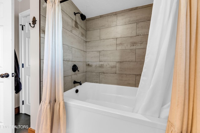 bathroom featuring shower / tub combo with curtain and wood walls