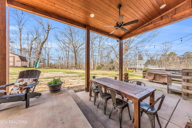 view of patio / terrace featuring ceiling fan, a jacuzzi, and a playground