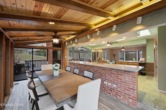 dining space with wooden ceiling, light hardwood / wood-style floors, and ceiling fan