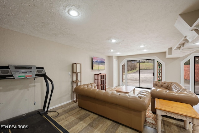 living room with light hardwood / wood-style flooring and a textured ceiling