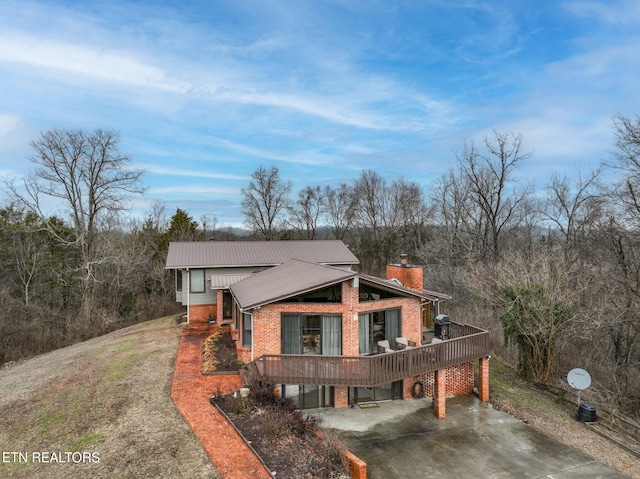 view of home's exterior with a wooden deck