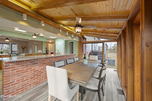 dining room featuring wood ceiling, ceiling fan, and light hardwood / wood-style flooring