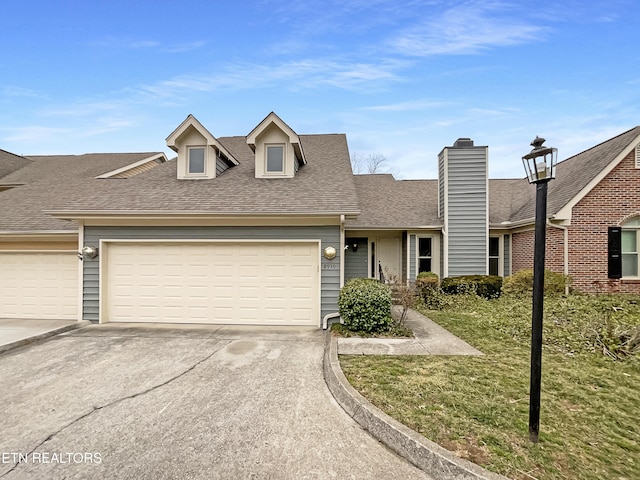 view of front of house with a garage and a front yard