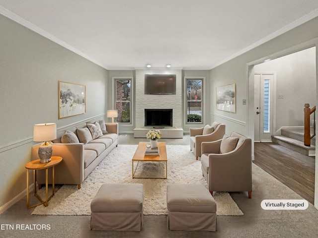 living room featuring crown molding and a large fireplace