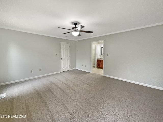 unfurnished room with ornamental molding, carpet flooring, and ceiling fan