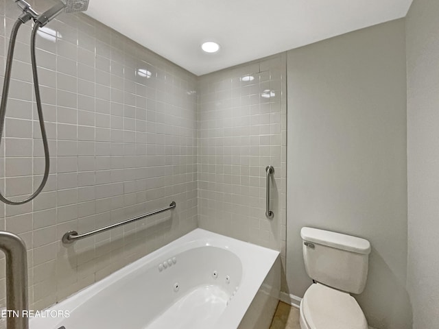 bathroom with tiled shower / bath combo and toilet