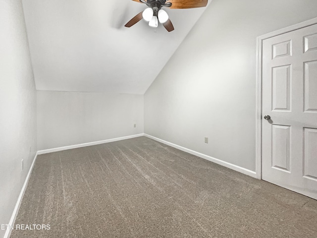 bonus room featuring lofted ceiling, ceiling fan, and dark colored carpet