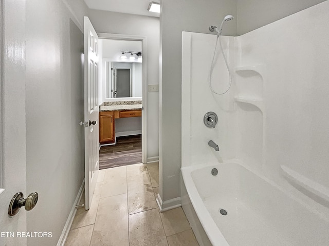 bathroom featuring tile patterned flooring, vanity, and tub / shower combination