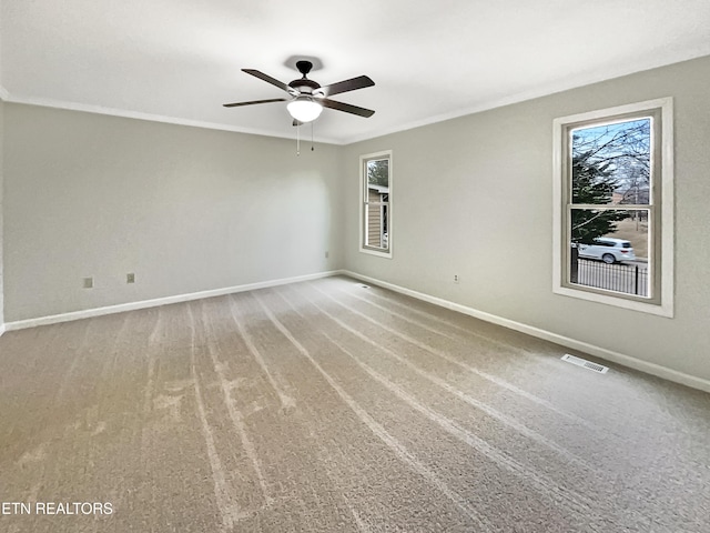 carpeted spare room featuring ornamental molding and ceiling fan