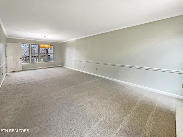 carpeted spare room featuring crown molding