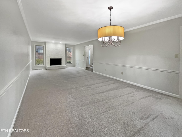 unfurnished living room with crown molding, a large fireplace, and carpet floors