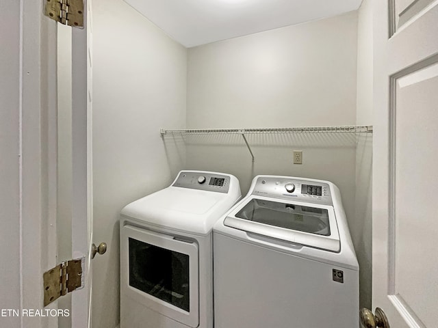 laundry room featuring washing machine and clothes dryer