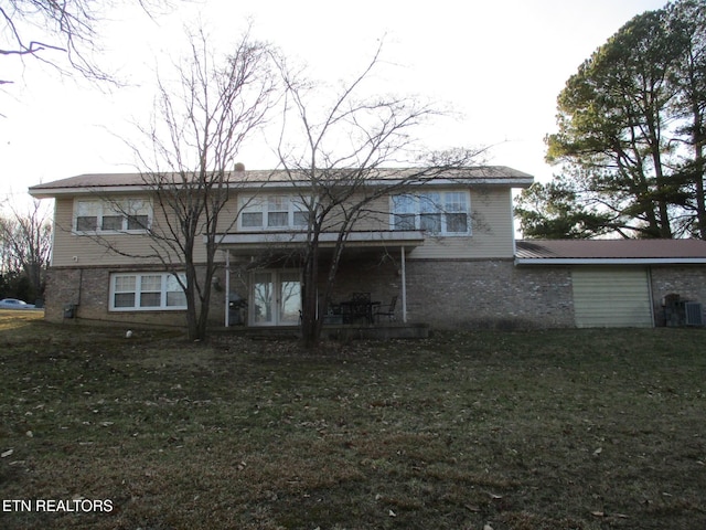 back of property with a lawn