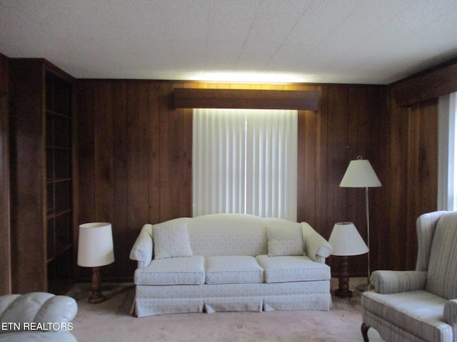 carpeted living room with wooden walls