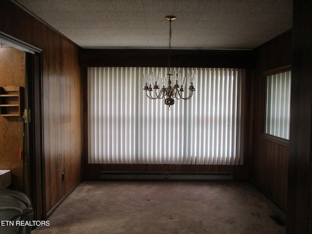 unfurnished dining area featuring carpet floors and wood walls