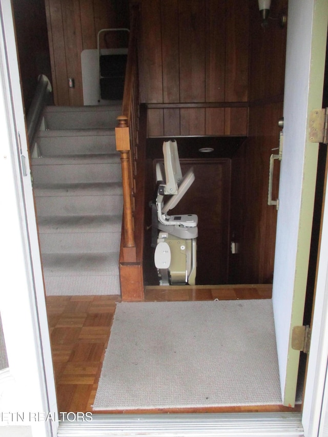 interior space with parquet floors and wood walls