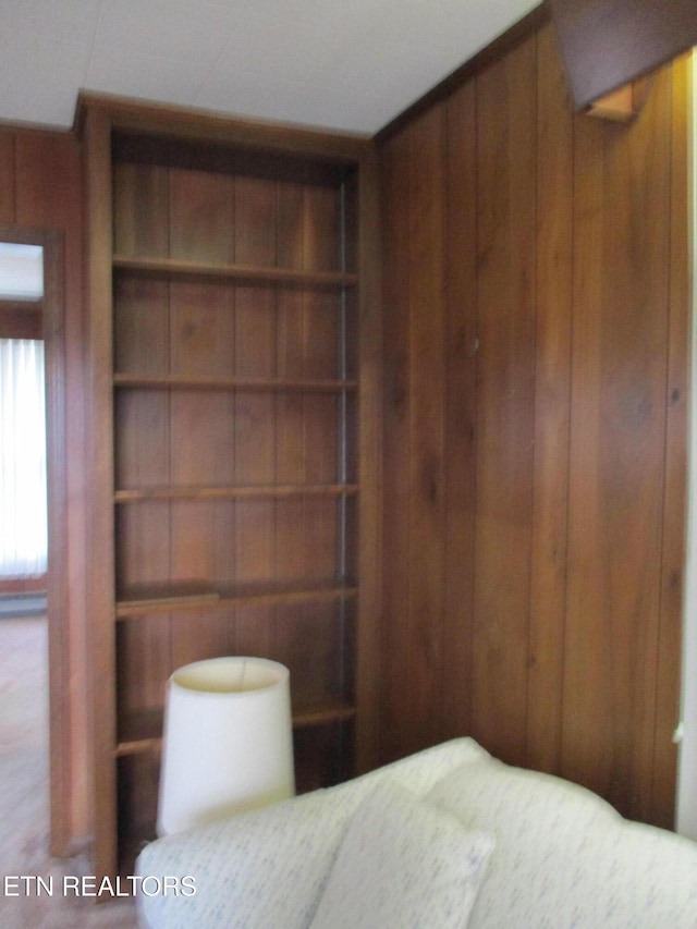 unfurnished bedroom with wood walls