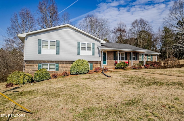 tri-level home with a porch and a front lawn