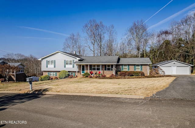 view of front of home with a garage, an outdoor structure, a front yard, and covered porch