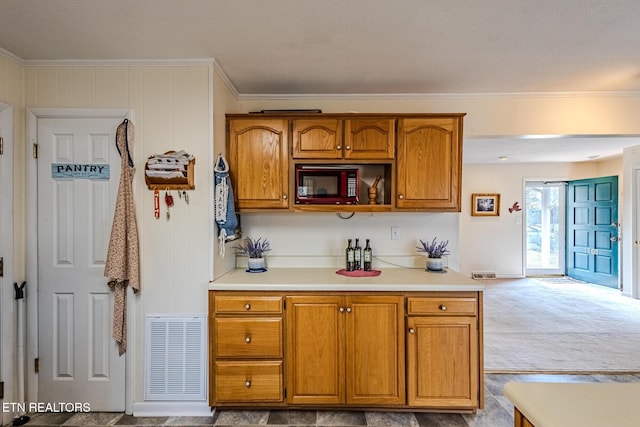 kitchen featuring light carpet and ornamental molding