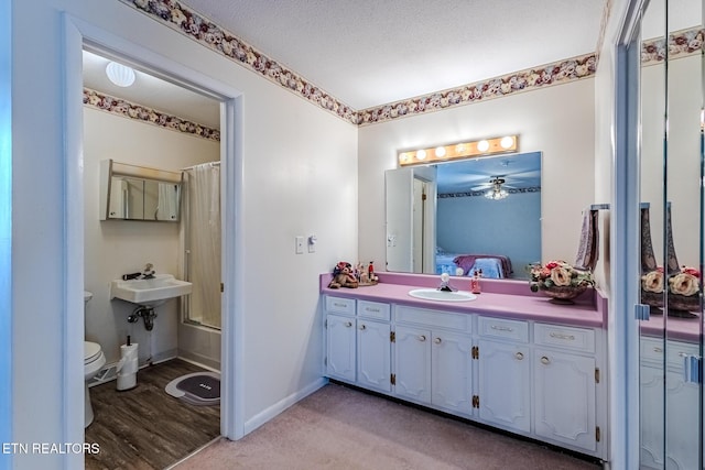 full bathroom with shower / tub combo, sink, a textured ceiling, and toilet