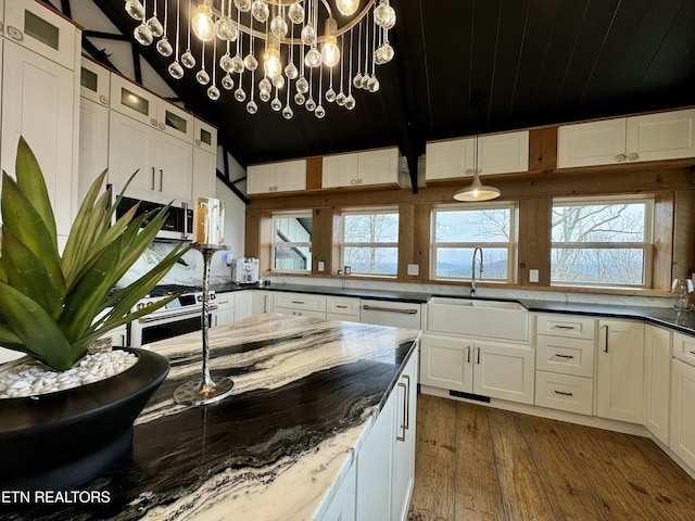 550 Steer Creek Rd, Tellico Plains, TN 37385 - kitchen with sink, dark stone countertops, hanging light fixtures, dark hardwood / wood-style floors, and white cabinets