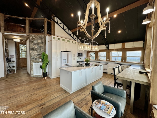 550 Steer Creek Rd, Tellico Plains, TN 37385 - kitchen featuring high end white refrigerator, high vaulted ceiling, a kitchen island, light hardwood / wood-style floors, and white cabinets