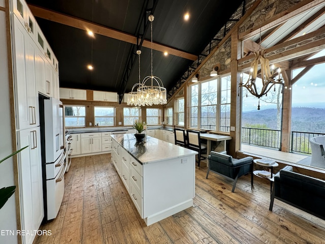 550 Steer Creek Rd, Tellico Plains, TN 37385 - kitchen featuring white fridge with ice dispenser, a center island, a mountain view, a notable chandelier, and white cabinets