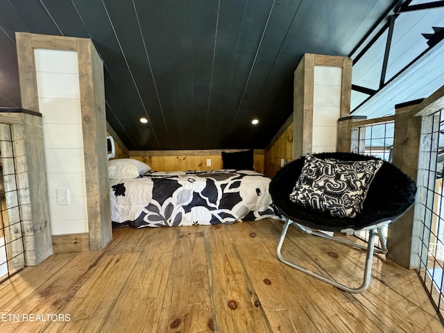 550 Steer Creek Rd, Tellico Plains, TN 37385 - bedroom with lofted ceiling, wooden walls, and light hardwood / wood-style flooring