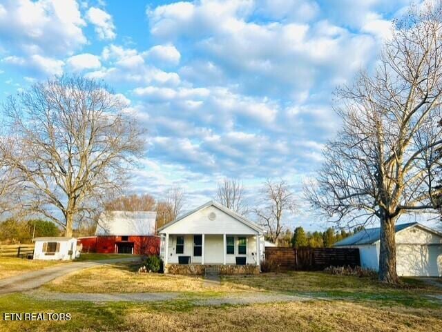 view of front of house with covered porch and a front lawn