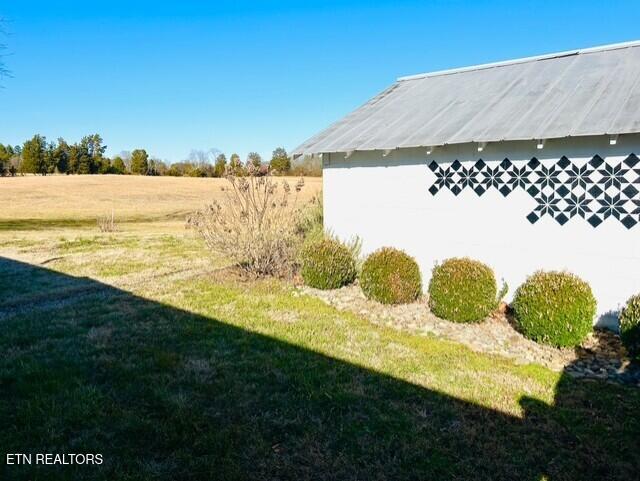 view of yard with a rural view