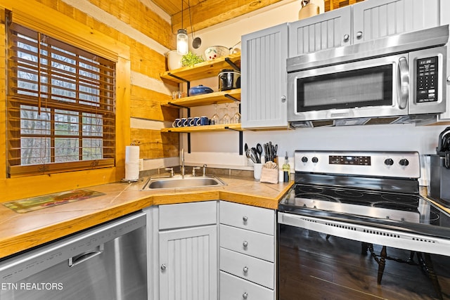 kitchen with pendant lighting, sink, and stainless steel appliances