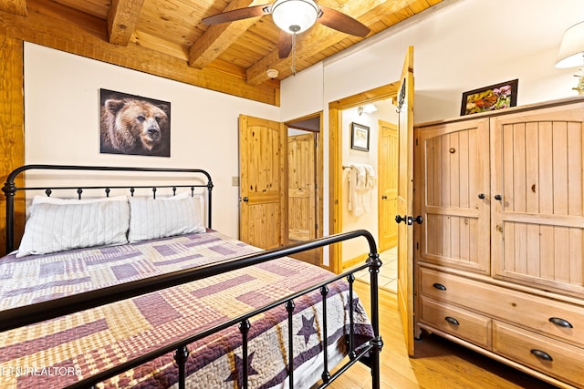 bedroom with wood ceiling, beam ceiling, light hardwood / wood-style flooring, and ceiling fan