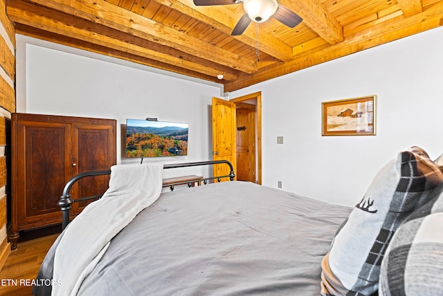 bedroom with beam ceiling, ceiling fan, hardwood / wood-style floors, and wood ceiling