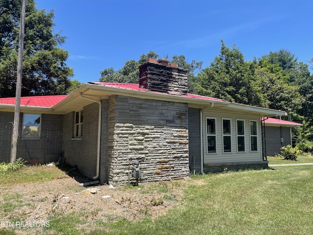 view of side of property with a lawn