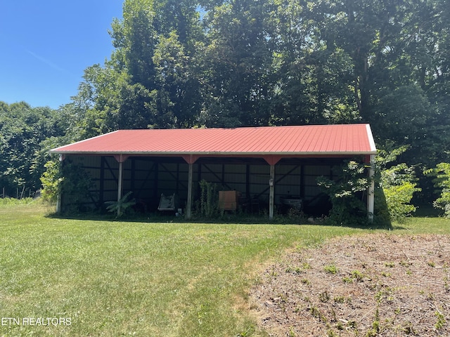 view of outdoor structure featuring a lawn