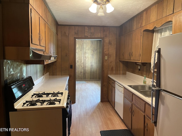 kitchen featuring dishwasher, refrigerator, gas range oven, and a textured ceiling