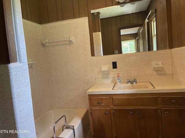 bathroom with vanity, a tub to relax in, and backsplash