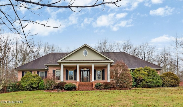 greek revival house with covered porch and a front lawn