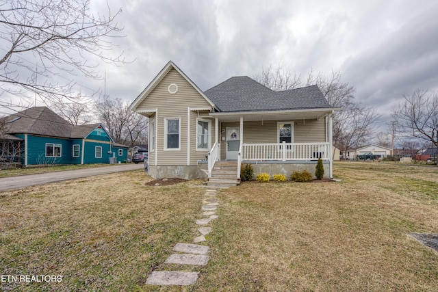 bungalow-style home with a front lawn and covered porch