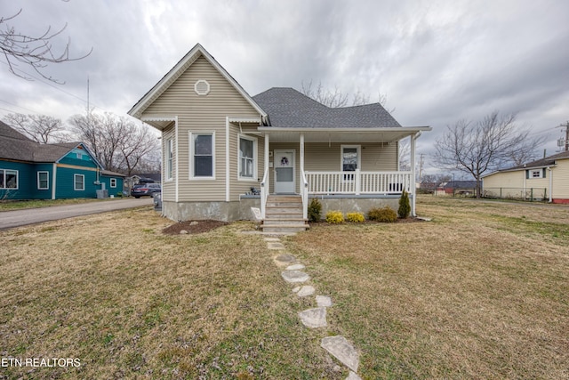 bungalow-style house with a front yard and a porch