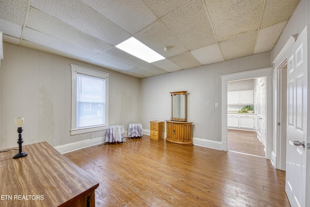 miscellaneous room with wood-type flooring and a paneled ceiling