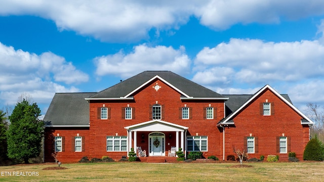 colonial-style house with a front lawn