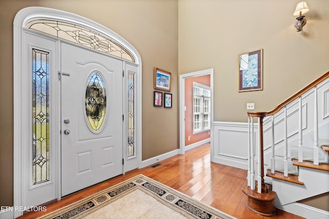 entryway featuring light hardwood / wood-style floors and a high ceiling